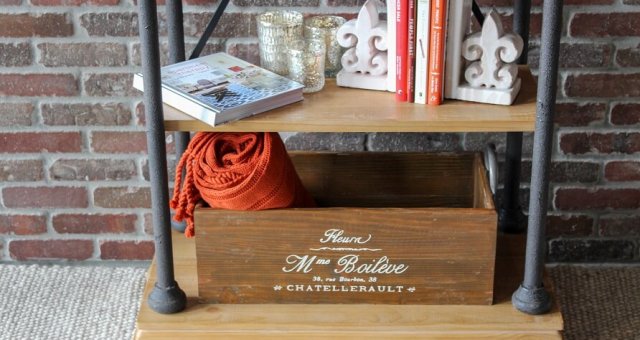 Last two shelves of a bookcase with bookends displayed as well as a box and books.