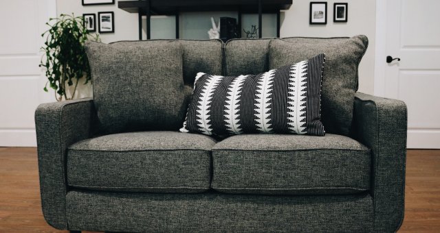 grey couch with black and white pillow