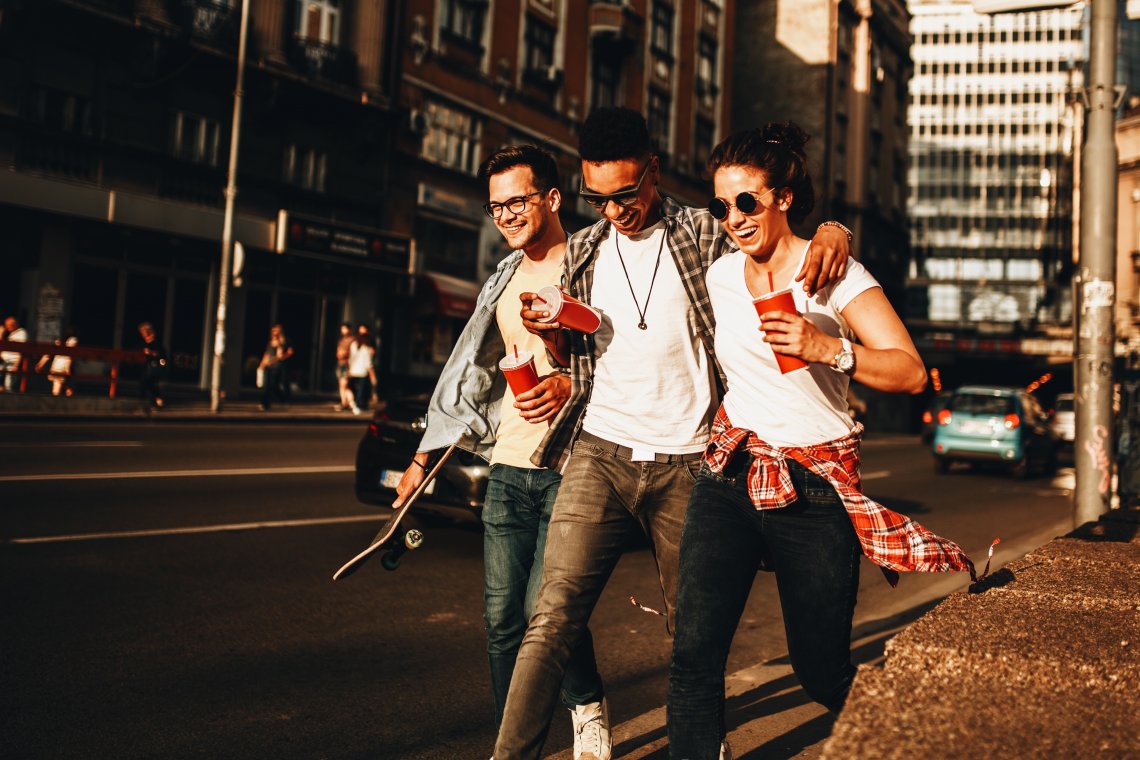 friends walking down sidewalk