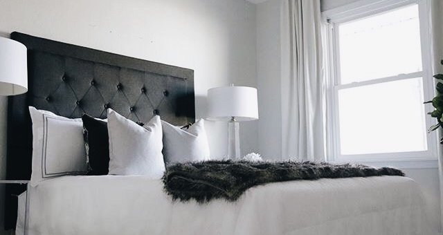 blavk bed frame with white sheets