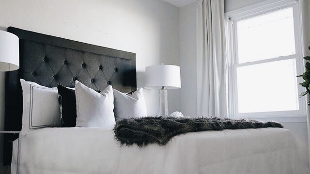 blavk bed frame with white sheets