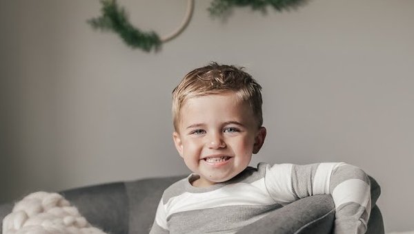 Child smiling in room.